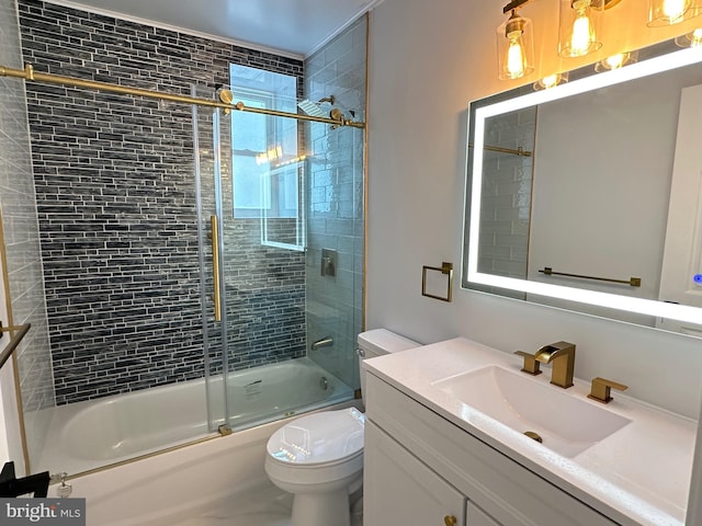 full bathroom featuring vanity, combined bath / shower with glass door, and toilet