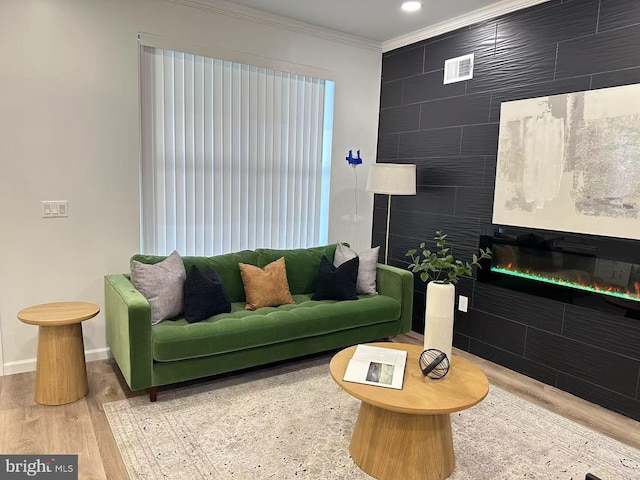 living room with hardwood / wood-style floors and crown molding