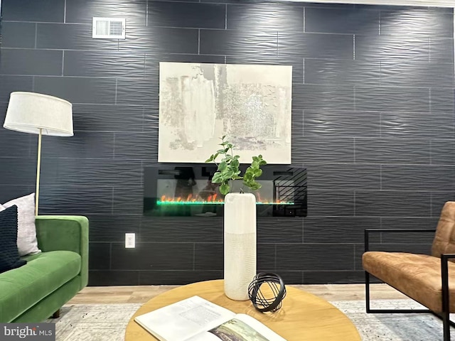 living area featuring tile walls