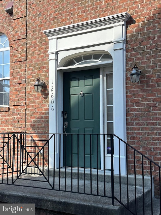 property entrance with brick siding