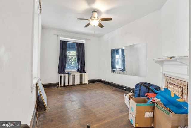 interior space with radiator, dark wood-type flooring, and ceiling fan