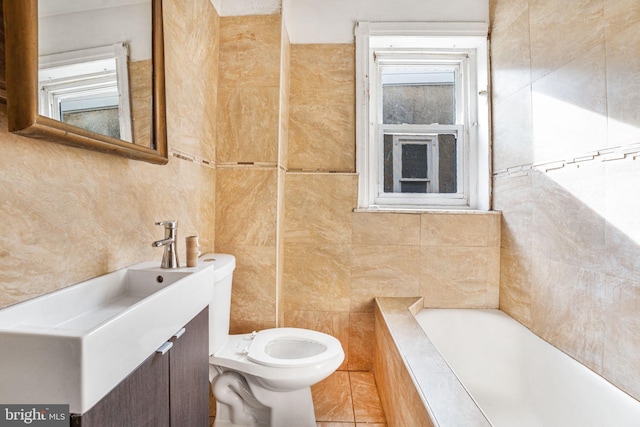 bathroom featuring toilet, tile walls, vanity, and a relaxing tiled tub