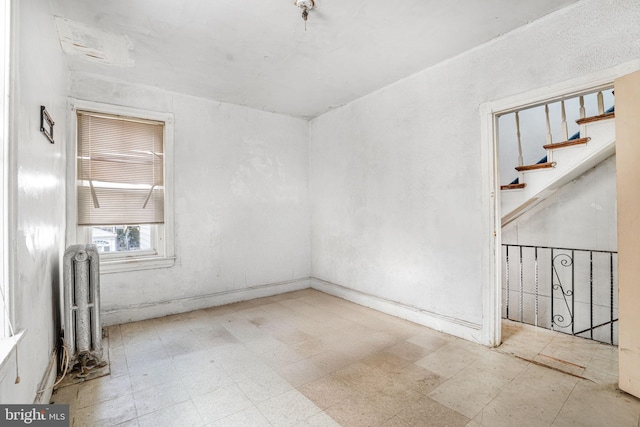 spare room featuring radiator heating unit