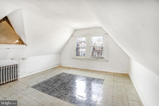 bonus room featuring lofted ceiling and radiator heating unit