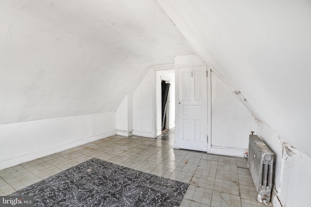 additional living space with lofted ceiling and radiator heating unit