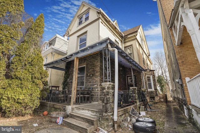 view of side of home with covered porch