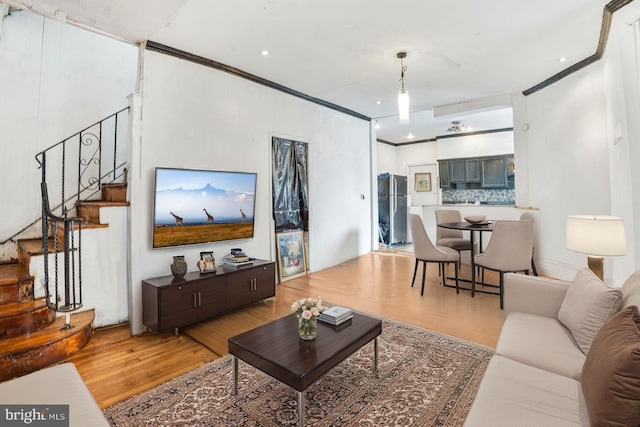 living room with hardwood / wood-style floors and ornamental molding