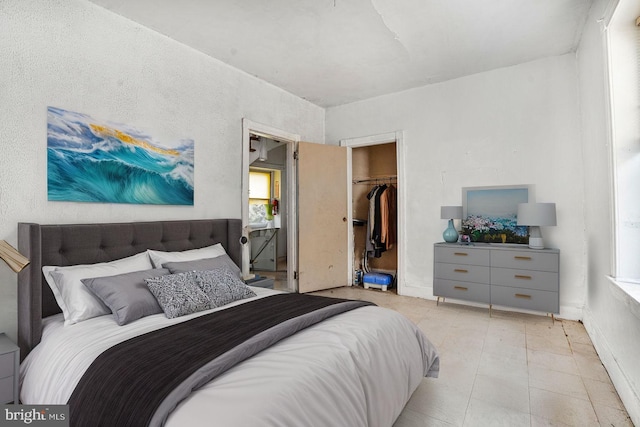 bedroom with a spacious closet and a closet