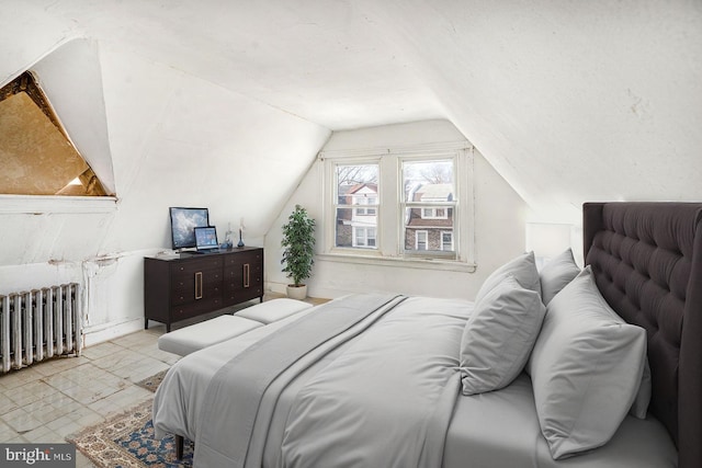 bedroom with radiator heating unit and vaulted ceiling