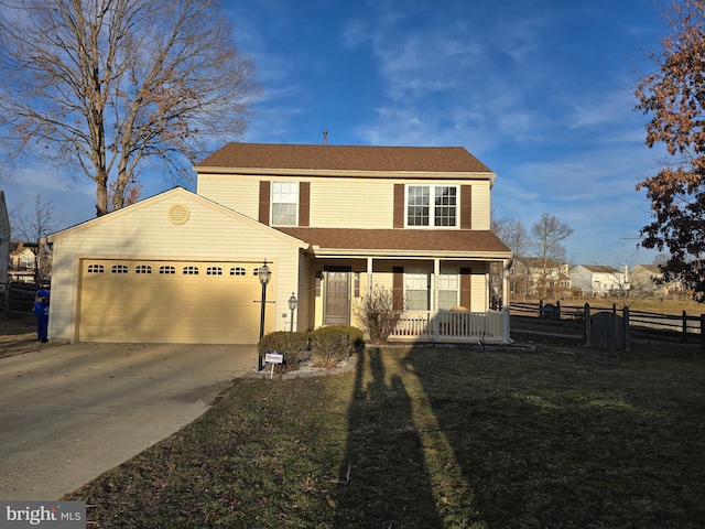 view of front of property with a garage, covered porch, and a front yard