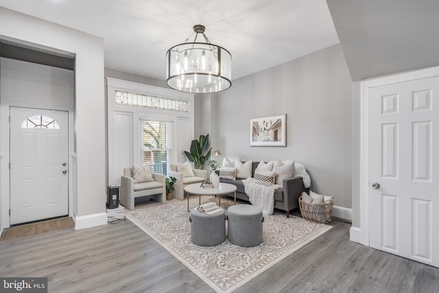 living room featuring a chandelier and hardwood / wood-style floors