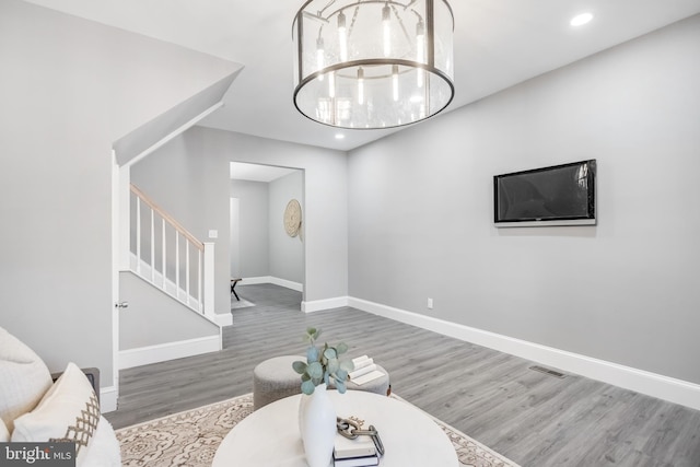 living room featuring hardwood / wood-style floors and a notable chandelier