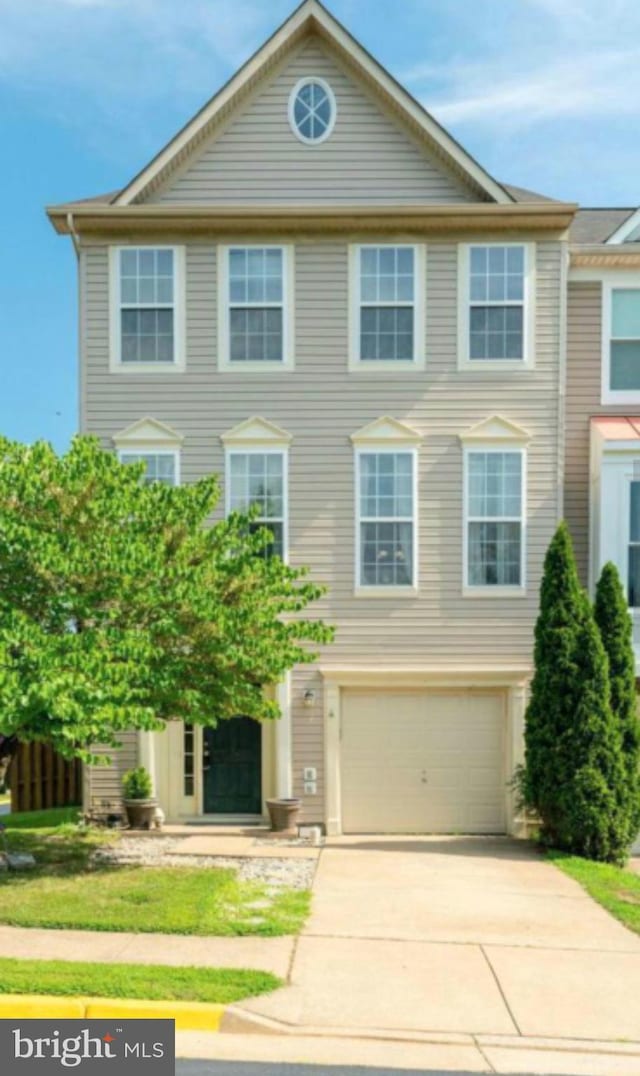 view of front of house with a garage and concrete driveway