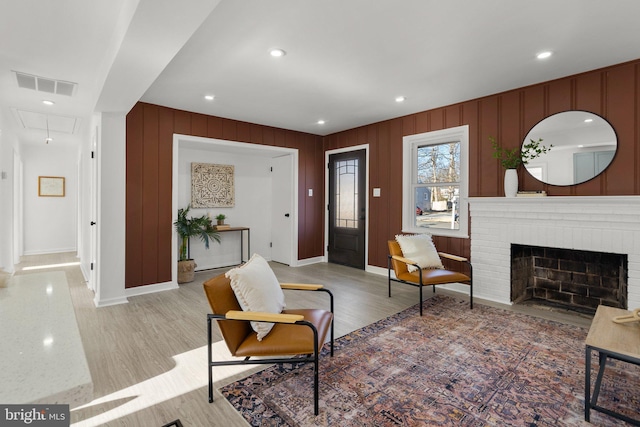 foyer entrance with a fireplace, recessed lighting, visible vents, light wood-type flooring, and baseboards