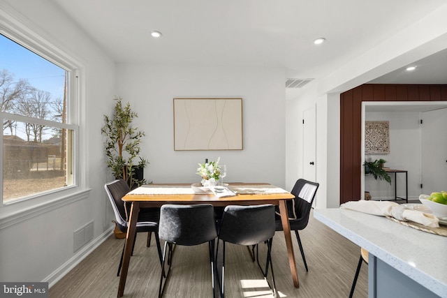 dining area featuring baseboards, visible vents, wood finished floors, and recessed lighting