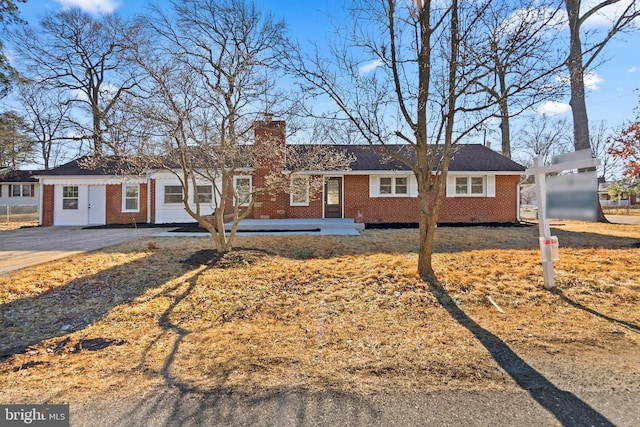 ranch-style house with brick siding and a chimney