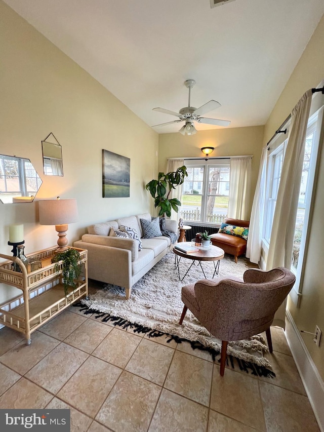 tiled living room featuring vaulted ceiling and ceiling fan