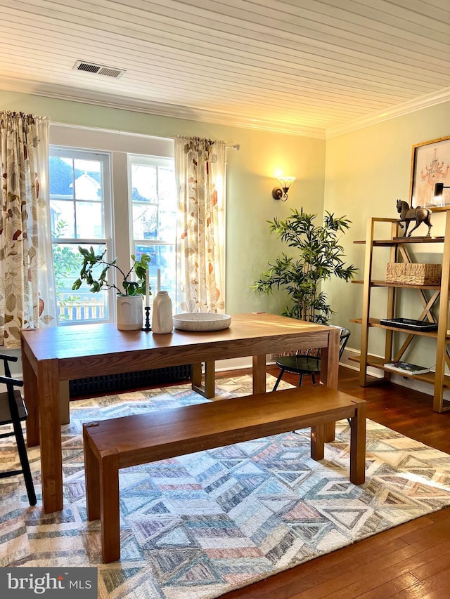 dining room featuring ornamental molding, dark hardwood / wood-style flooring, and wooden ceiling