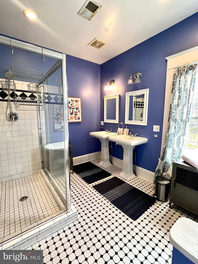 bathroom featuring a shower with shower door