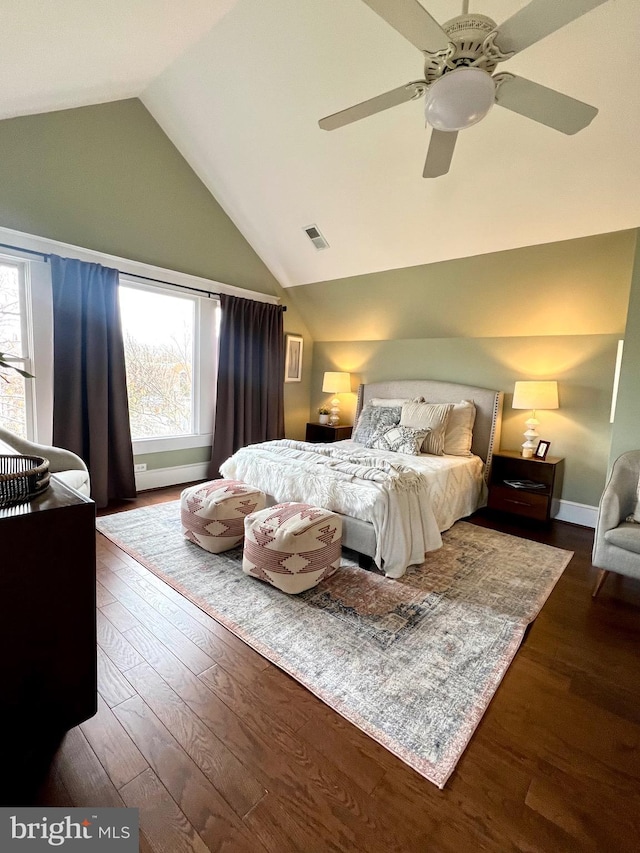 bedroom with ceiling fan, dark hardwood / wood-style floors, and vaulted ceiling