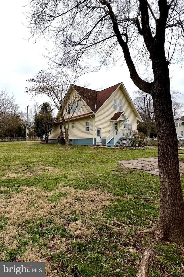 view of home's exterior with a yard