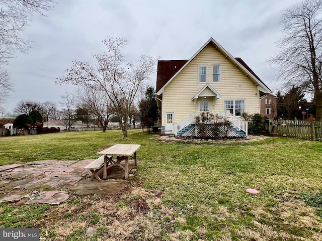 back of property featuring a lawn