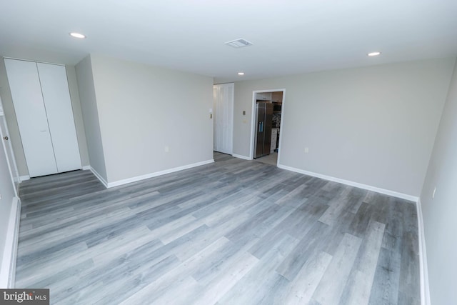 spare room with wood-type flooring