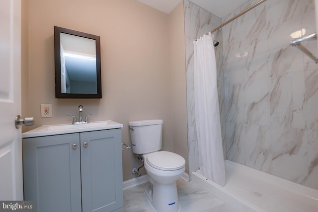 bathroom featuring marble finish floor, toilet, vanity, a shower stall, and baseboards