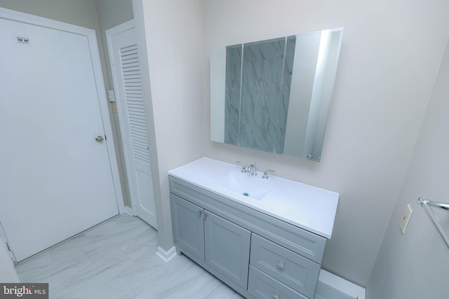 bathroom with marble finish floor and vanity