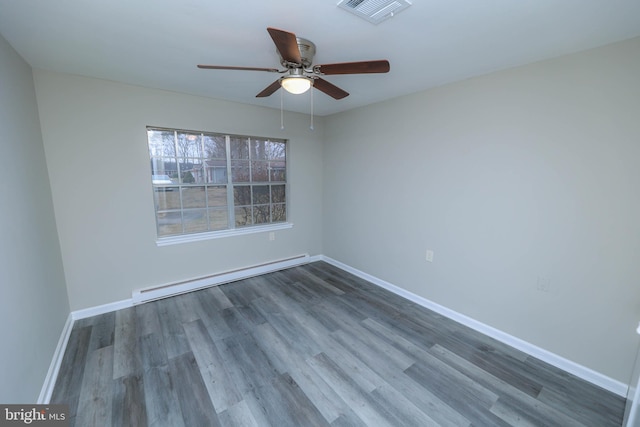 empty room with a baseboard radiator, visible vents, baseboards, and wood finished floors