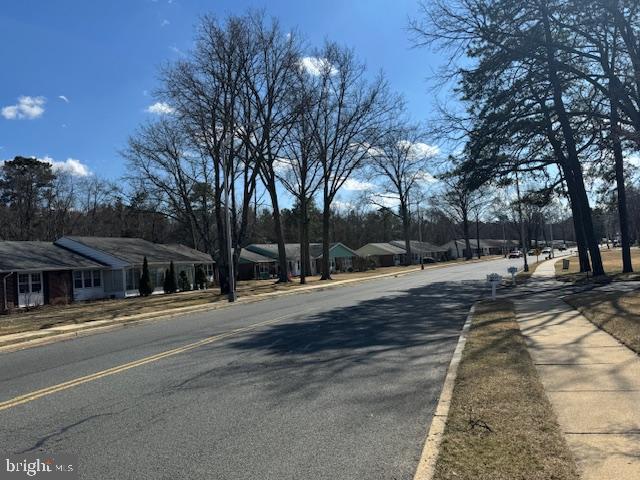 view of road with curbs and sidewalks