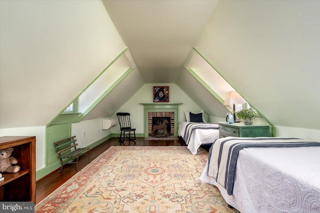 bedroom with lofted ceiling, baseboards, and wood finished floors