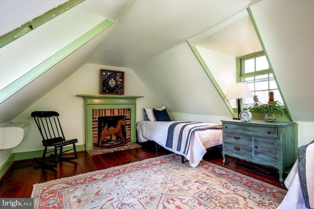 bedroom featuring lofted ceiling and wood-type flooring