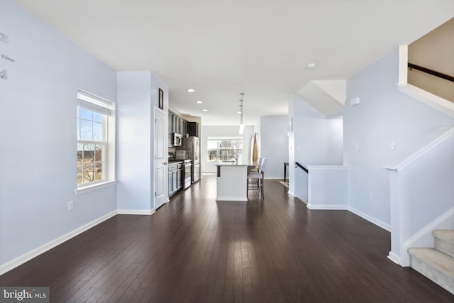 unfurnished living room featuring dark wood-type flooring