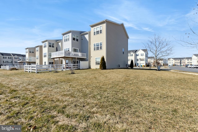 back of property featuring a lawn