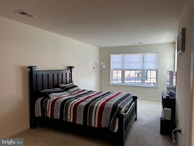 bedroom featuring light colored carpet