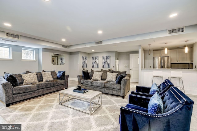 living area featuring visible vents and recessed lighting