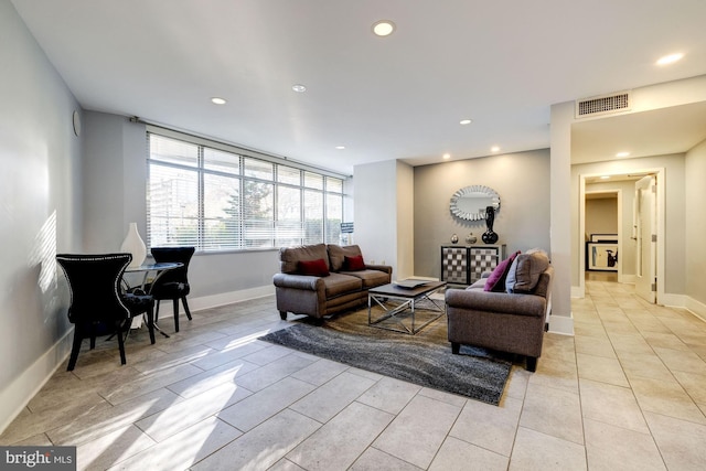 living room featuring baseboards, visible vents, and recessed lighting