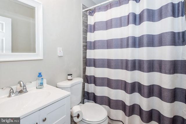 bathroom with vanity, toilet, and walk in shower