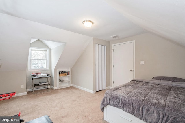 carpeted bedroom featuring vaulted ceiling