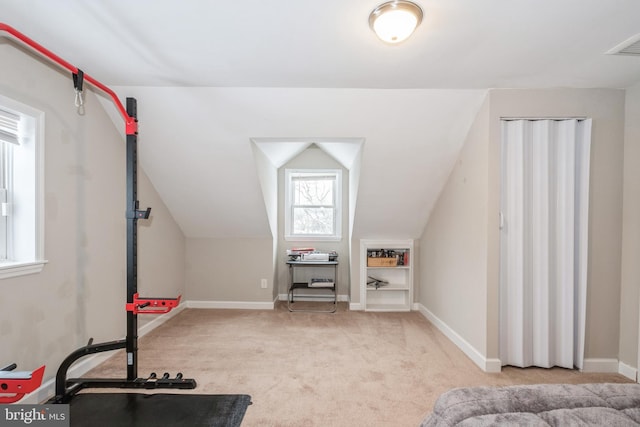 interior space with lofted ceiling and light colored carpet