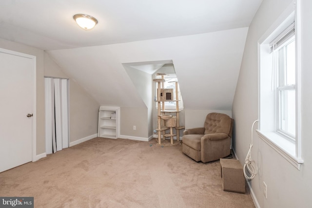 living area with vaulted ceiling and light carpet