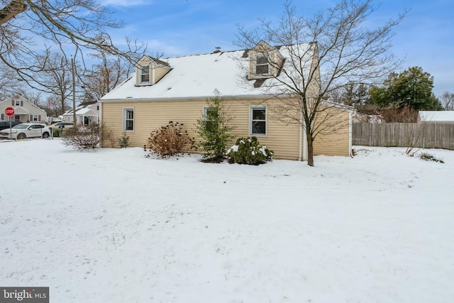 view of snow covered rear of property