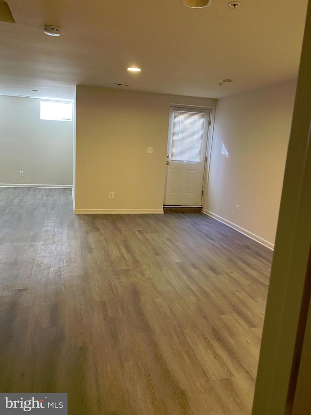 unfurnished room with hardwood / wood-style flooring