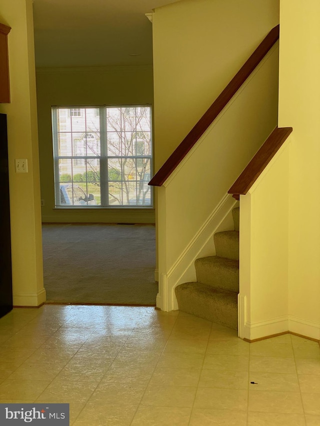 stairs featuring crown molding