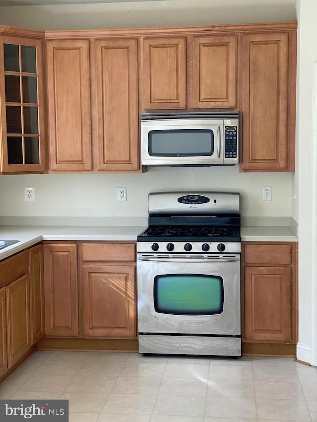 kitchen featuring appliances with stainless steel finishes and light tile patterned floors