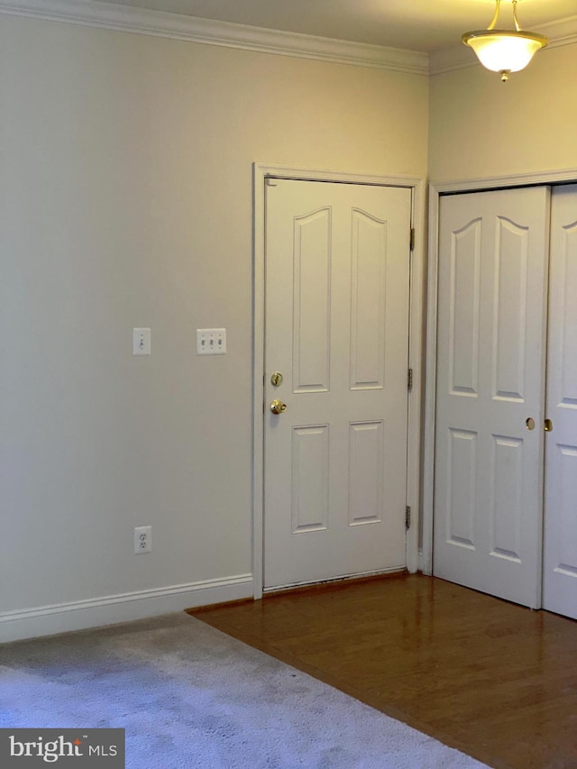 entryway featuring crown molding and wood-type flooring