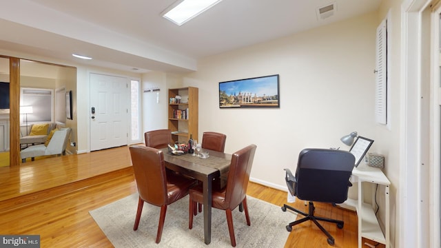 dining space with hardwood / wood-style floors