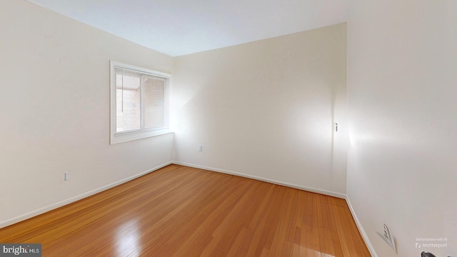 unfurnished room featuring hardwood / wood-style flooring