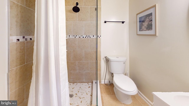 bathroom featuring curtained shower, tile patterned floors, and toilet